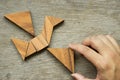 Man hold triangle to fulfill tangram puzzle in bird shape Royalty Free Stock Photo