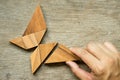 Man hold triangle to fulfill tangram puzzle in butterfly shape & x28; Royalty Free Stock Photo