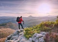 Man hold tripod. Hiker admiring stunning mountain range