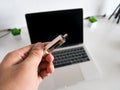 Man Hold the USB Type-C Memory Card Reader with Laptop in the Background Royalty Free Stock Photo