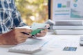 Man holding account passbook with pencil on  financial report.Finances Saving Economy concept. Royalty Free Stock Photo