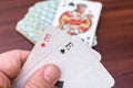 Man holding aces and trumps in his hands in a card game Royalty Free Stock Photo