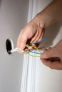 Man is holding adhesive tape in his hands.  Electrical insulator for light bulb. Maintenance repair works in the flat. Restoration Royalty Free Stock Photo