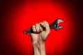 Man holding adjustable wrench over red Royalty Free Stock Photo