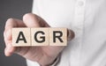 Man holding agr word on wooden cube