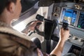 Man holding airplane wheel in cockpit