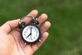 Man holding an alarm clock in hands Royalty Free Stock Photo