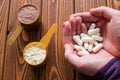 Man holding amino acid capsules