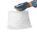 Man holding ammonium nitrate pellets above sack on white background, closeup. Mineral fertilizer