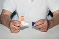 Man holding asthma inhaler in his hands.