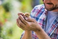 Man holding a baby chick in his hands very carefully