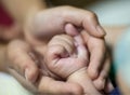 Man holding a baby hand extreme close-up