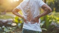 Man holding back in pain after exercise in the park muscle injury and overexertion