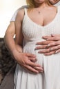 Man holding belly of his pregnant wife Royalty Free Stock Photo