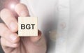 Man holding bgt word on wooden cube Royalty Free Stock Photo