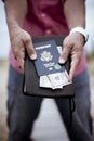 Man Holding Bible Money & Passport