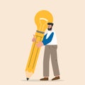 Man holding a big pencil with an idea light bulb inside of it. Process of creating an idea. Creativity and imagination to create Royalty Free Stock Photo