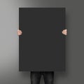 Man holding black poster mockup