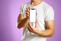 A man holding a black smartphone with a white blank screen. Smartphone with large screen. Close up. Isolated background Royalty Free Stock Photo