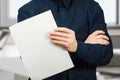 Man holding blank sheet of paper. Young guy pointing at paper sheet. Promotion concept Royalty Free Stock Photo