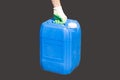 A man holding a blue canister