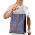 Man holding a blue gift bag. Close up. Isolated on white background Royalty Free Stock Photo