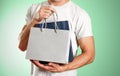 Man holding a blue and grey gift bags. Close up. Isolated background Royalty Free Stock Photo