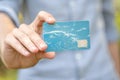 Man holding a blue premium VIP social club membership advantage card in hand, empty template, mockup, clouds, copy space, card