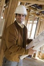 Man Holding Blueprint In Construction Site Royalty Free Stock Photo