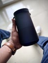 A Man holding the bluetooth speaker with his hand Royalty Free Stock Photo