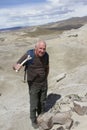 Man holding bone with dinosaur remains Royalty Free Stock Photo