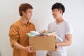 Man holding a book and clothes donate box. Donation concept. Royalty Free Stock Photo