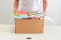 Man holding a book and clothes donate box. Donation concept Royalty Free Stock Photo