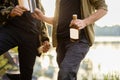 Man holding bottle with alcohol at picnic Royalty Free Stock Photo