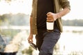 Man holding bottle with alcohol at picnic Royalty Free Stock Photo