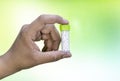 A man holding a bottle of homeopathic pills on a mix green yellow background. Medicine and treatment Royalty Free Stock Photo