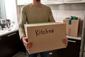 Man holding box with glass and kitchen things