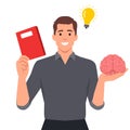 man holding brain while studying for school. Idea thinking. He is getting idea from book