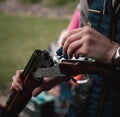 Man holding a break open double barreled shotgun. Shooting clay disks as a sport in the uk. Beautiful wooden engraved masterpiece