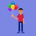 Man holding a bunch of colorful balloons.
