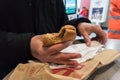 Man holding a burger and packaging in McDonalds Fast Food