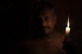 The man holding a burning candle in the dark Royalty Free Stock Photo