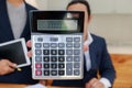 Man holding calculator in hand. Business man showing value on calculator