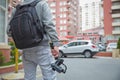 An unidentified man holding gimbal a camera stabilizer . Man holding gimbal stabilizer outdoor. Gimbal Operator with black Royalty Free Stock Photo