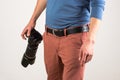 Man is holding a camera near his hip Royalty Free Stock Photo