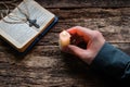 Man holding a candle in front of the bible and cross Royalty Free Stock Photo