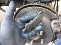 Man holding car brake shoe