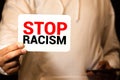 Man holding cardboard banner with STOP RACISM message Royalty Free Stock Photo