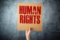 Man holding cardboard paper with HUMAN RIGHTS title Royalty Free Stock Photo