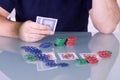 Man Holding Cards on the Table in Texas Hold'em